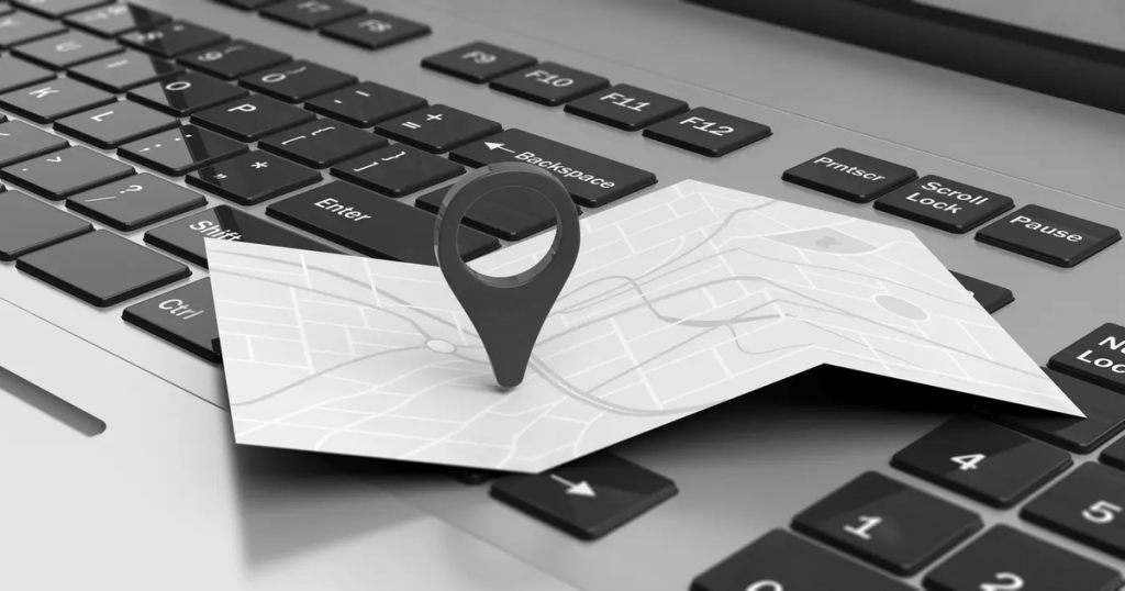 Map pin on laptop keyboard