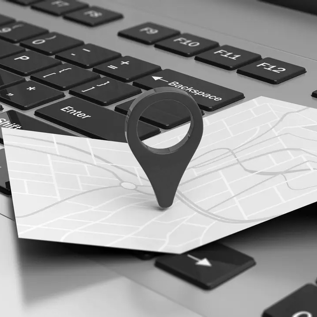 Map pin on laptop keyboard